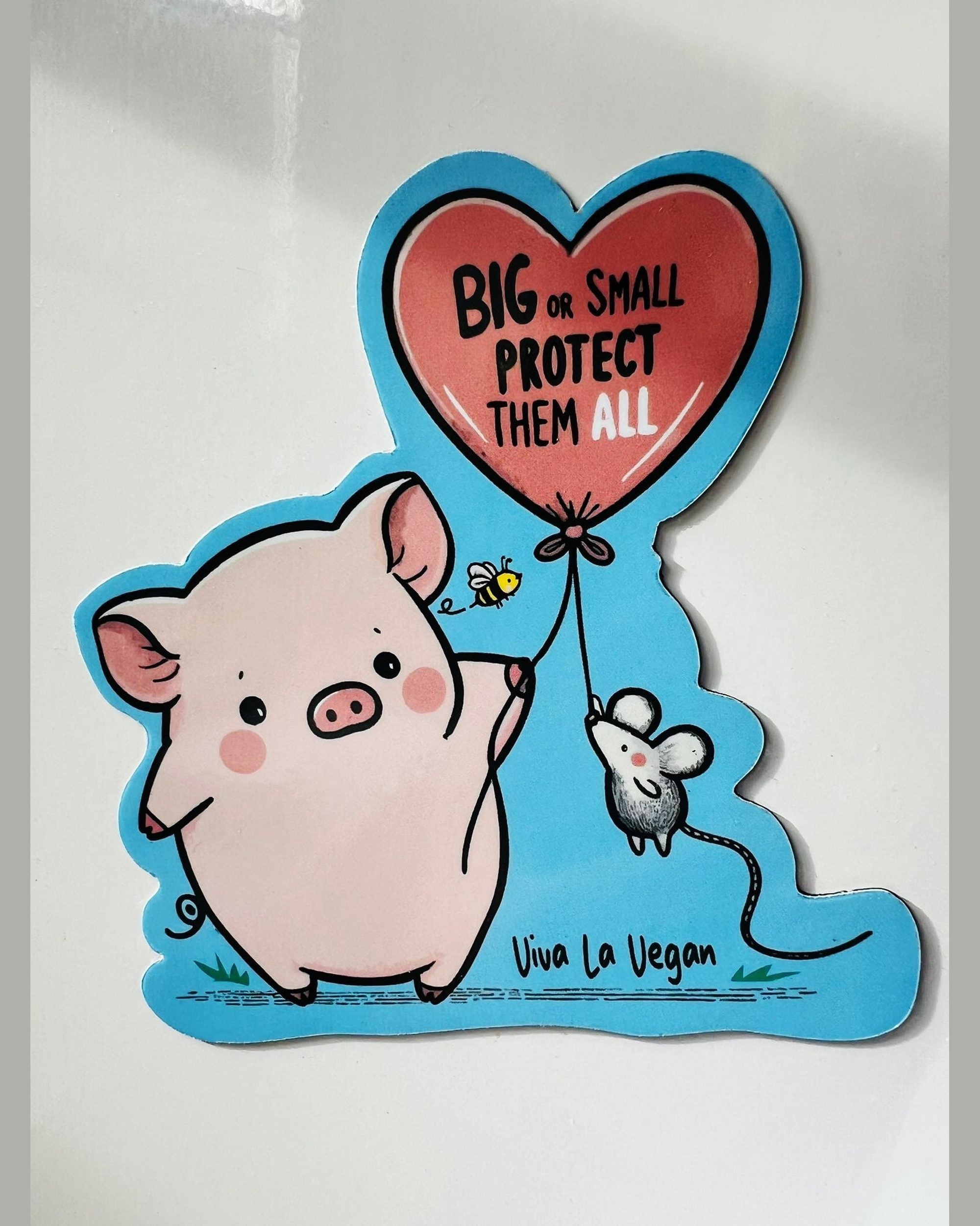 A custom shaped magnet of a pig and a mouse holding a balloon with the writing &