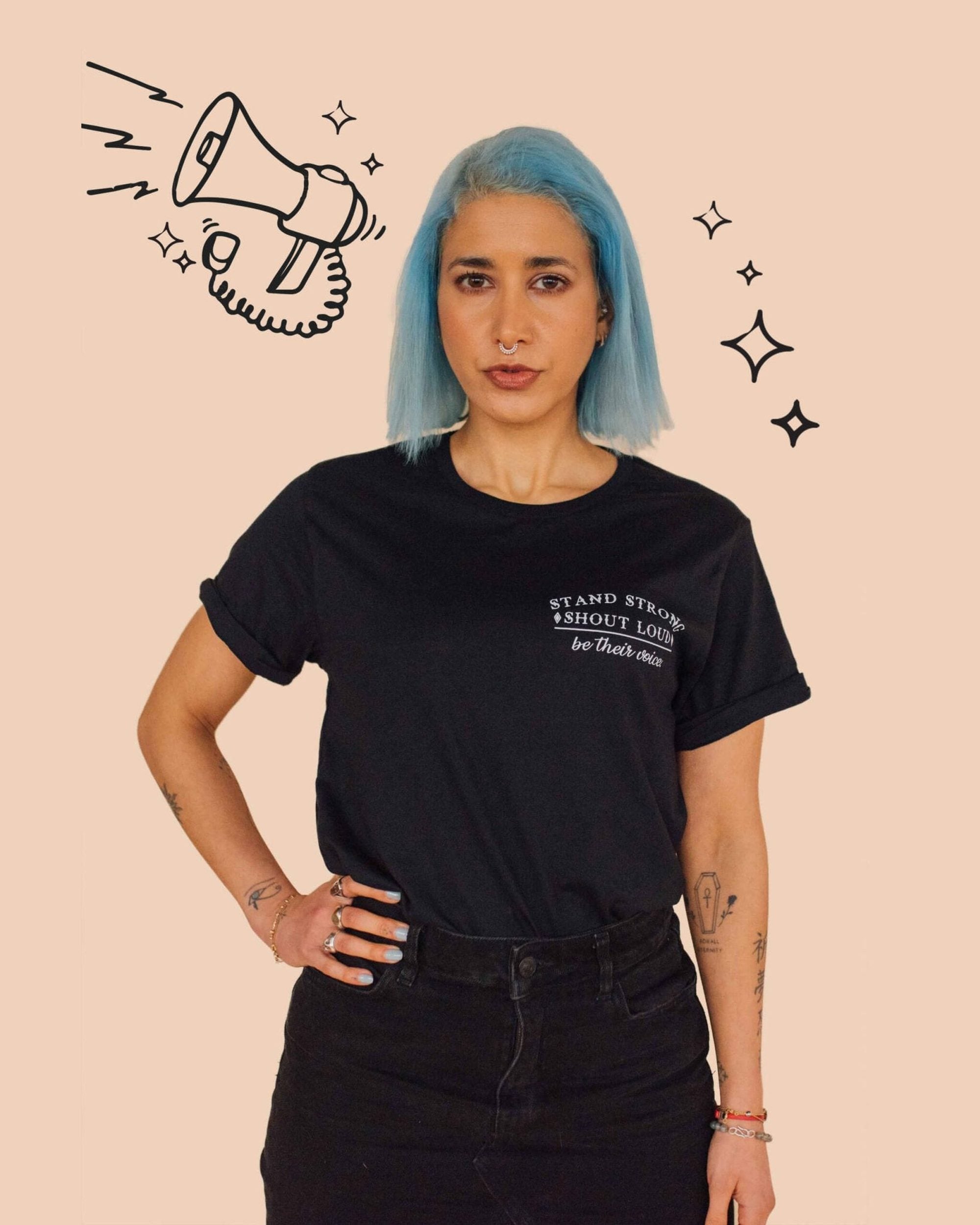 A blue haird model standing against a wall wearing Eco-ethical brand Viva La Vegan&