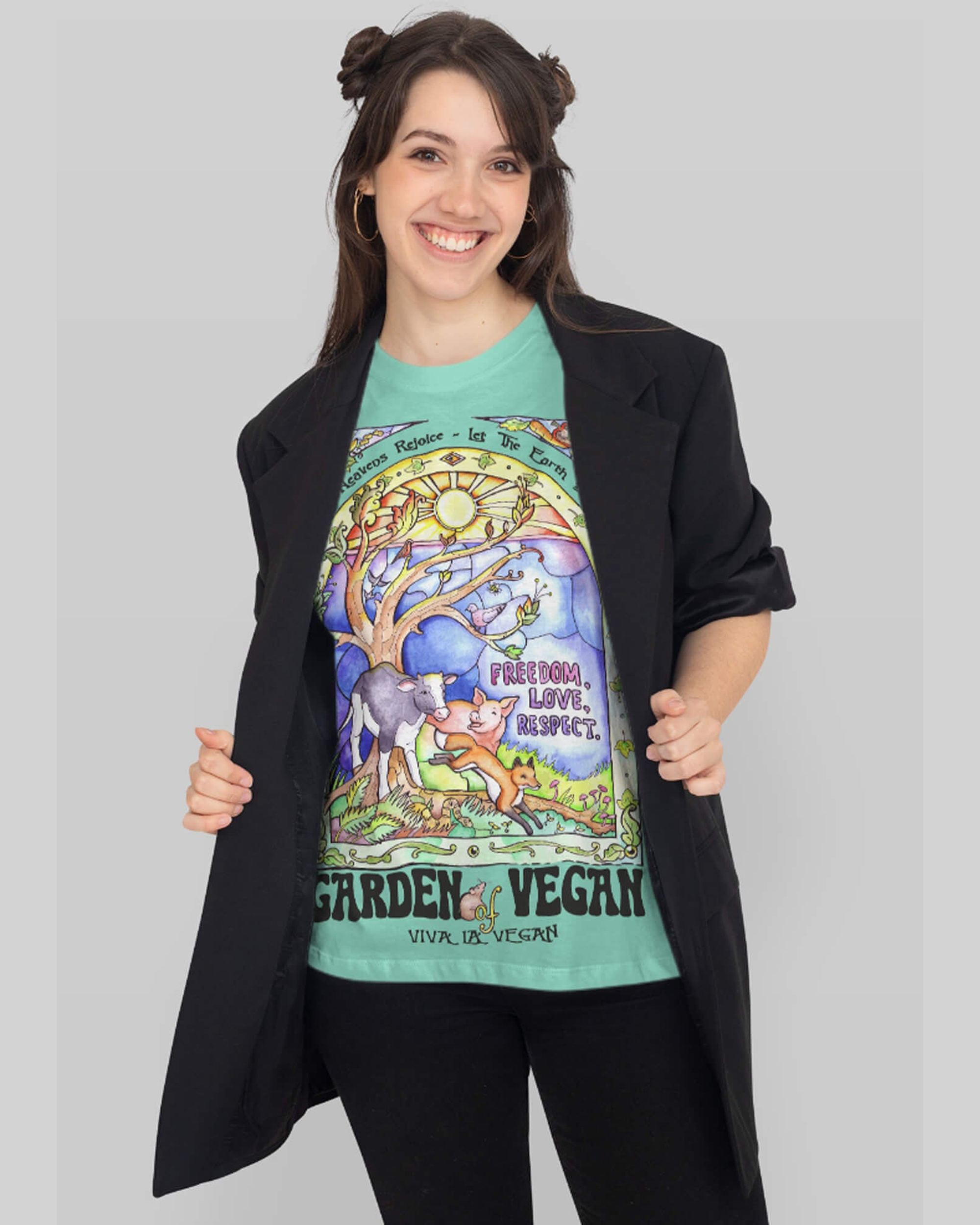 Smiling dark haired woman wearing a green Garden of Vegan Tshirt by Viva La Vegan