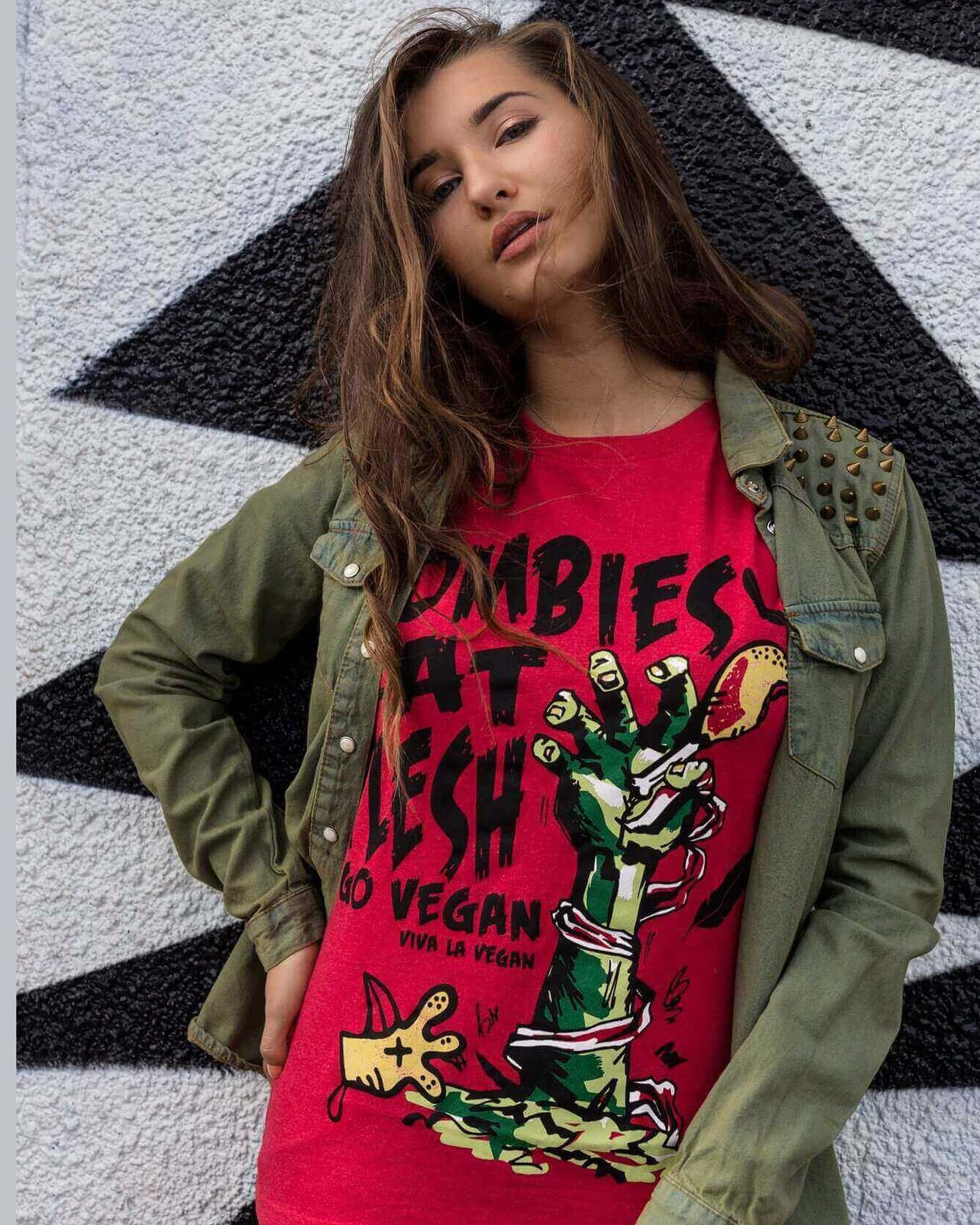 gender-women wearing a Unisex Tshirt with large Zombies Eat Flesh - Go Vegan graphic