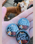 Camp beagle supporter badges shown on a hand surrounded by dogs By Viva La Vegan