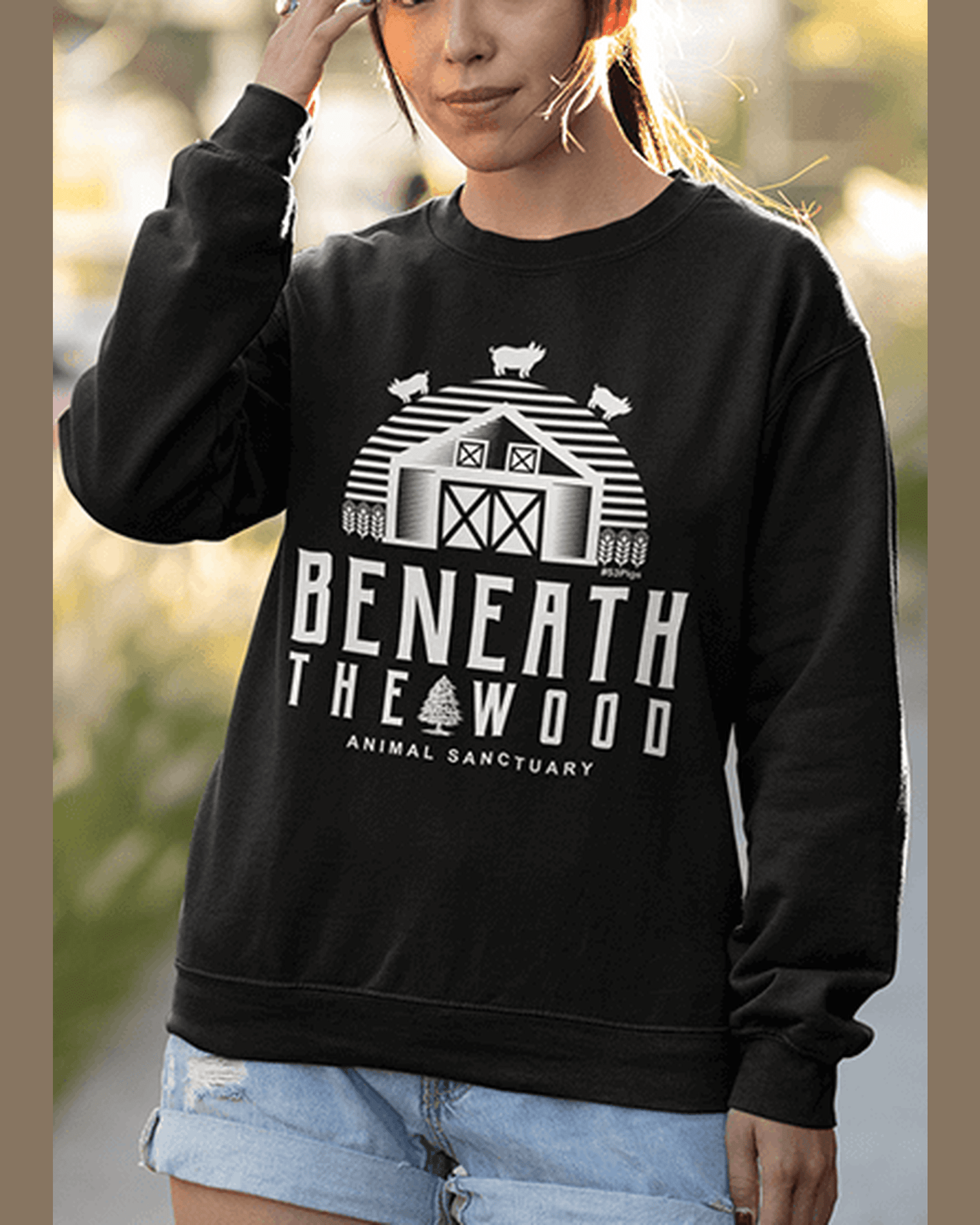 crop view of Beneath the woods charity sweatshirt logo . Black sweatshirt with a white print, in black. By eco ethical brand Viva La Vegan