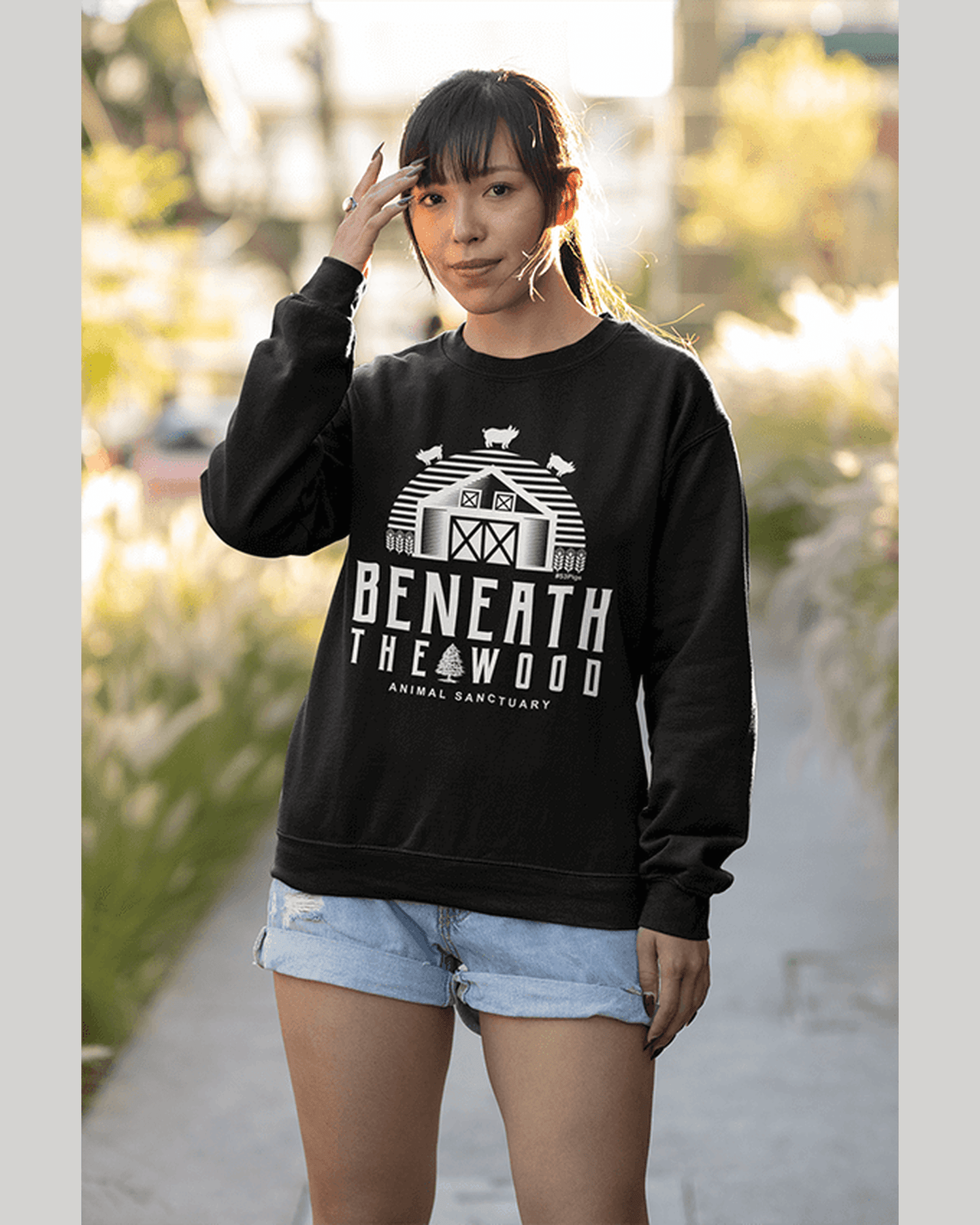 Beneath the woods charity sweatshirt in black. worn young woman. By eco ethical brand Viva La Vegan