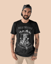 Male Model wearing a Unisex Tshirt in black that has grapghic design and word relating to breaking the cylcle of animal abuse.