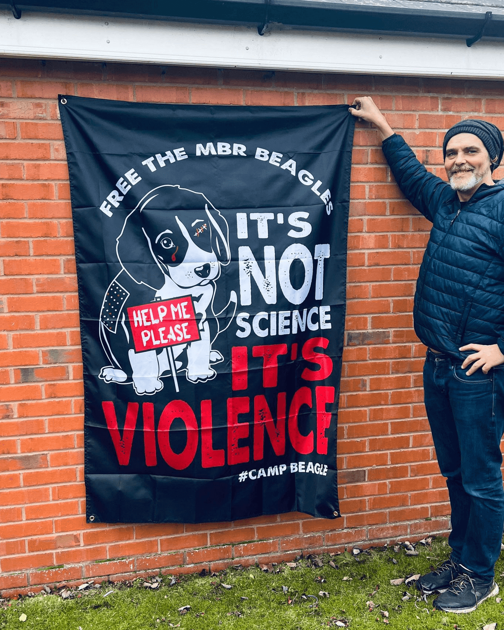 Camp Beagle banner next to a man to show size by viva la vegan