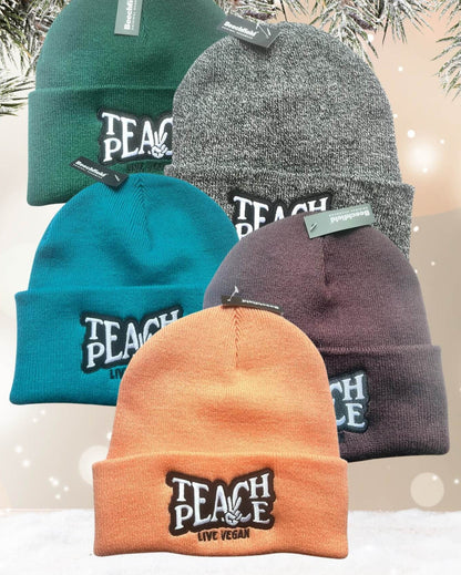 Flatlay photo of 5 cuffed beanies with a black and white embroidery &
