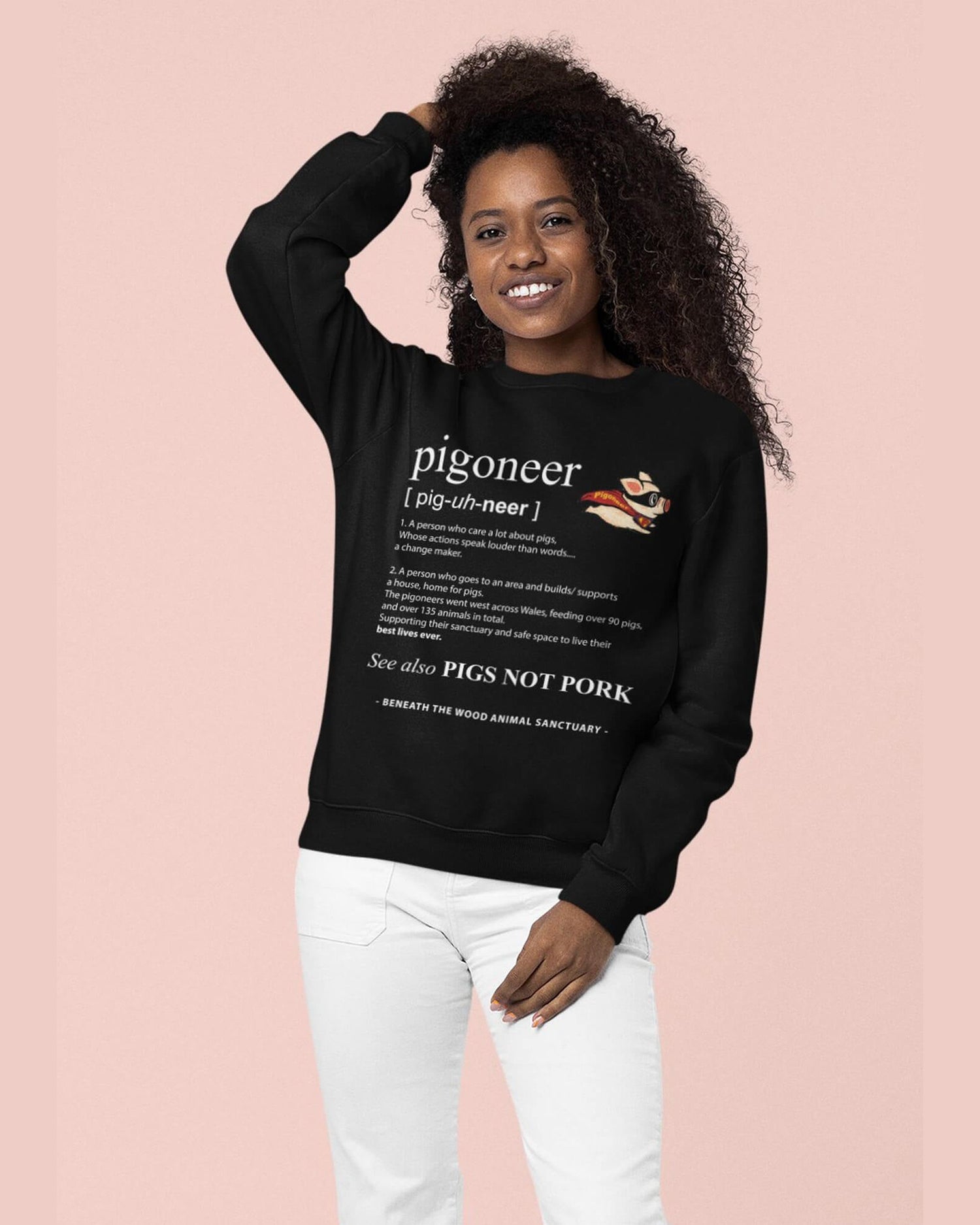 Smiling lady wearing a black pigoneer sweatshirt by Viva La Vegan