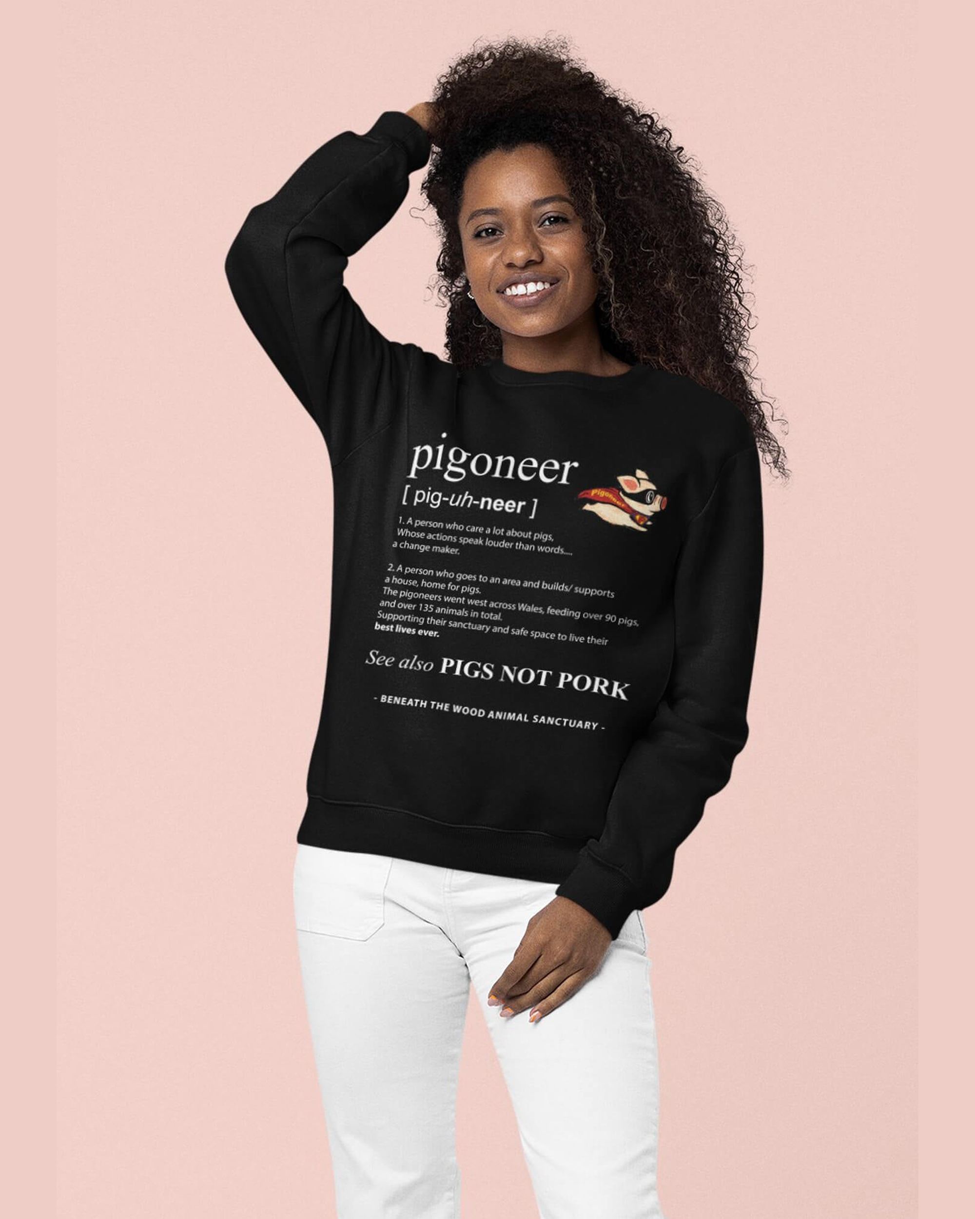 Smiling lady wearing a black pigoneer sweatshirt by Viva La Vegan