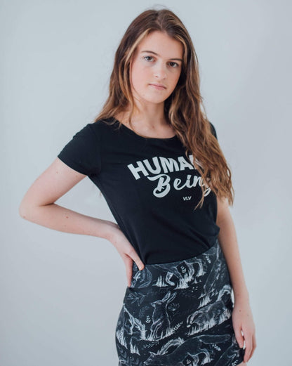 Vegan Model wearing all over animal print mini skirt matched with a humane being tshirt