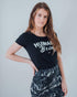 Vegan Model wearing all over animal print mini skirt matched with a humane being tshirt