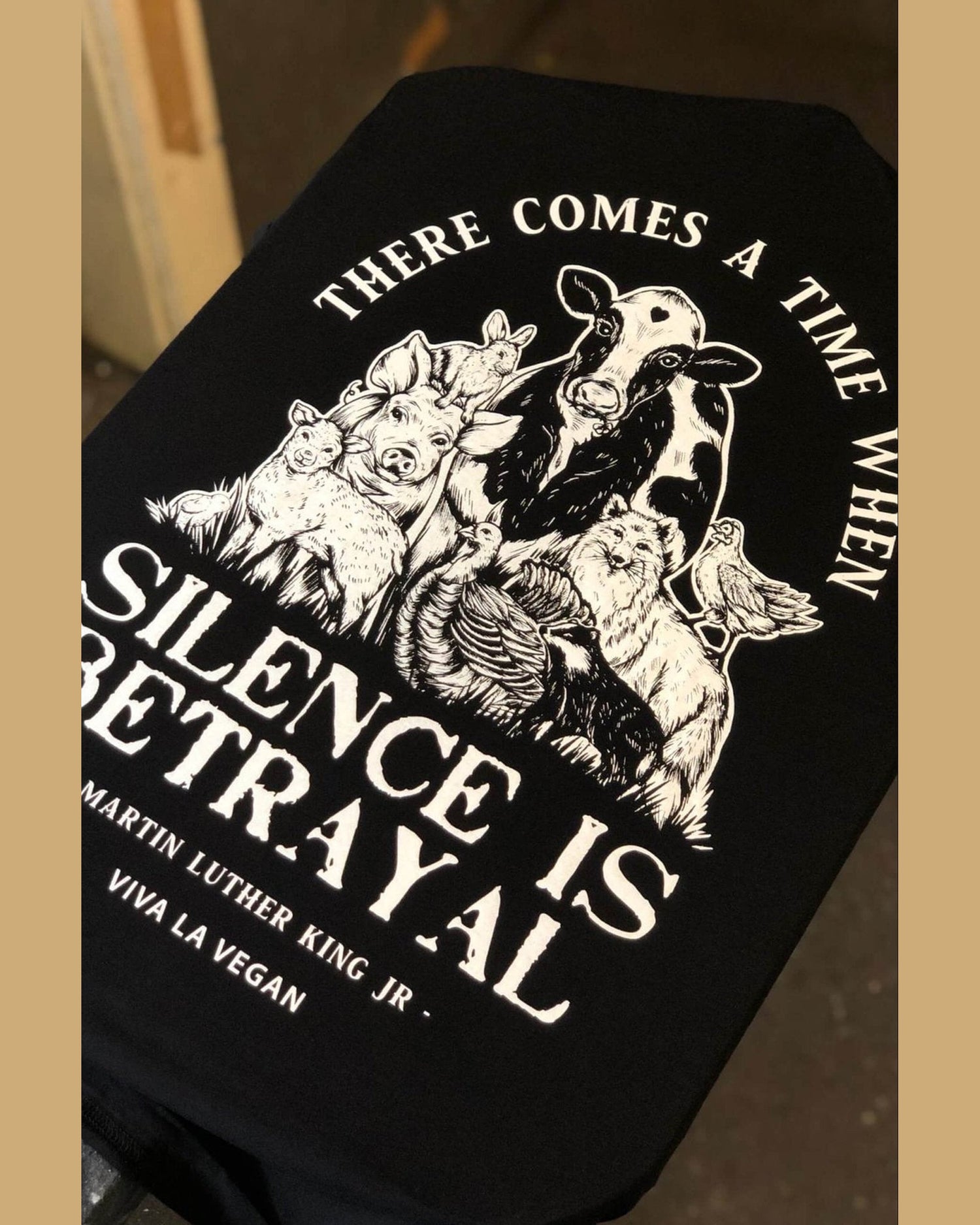 Detailed display of vegan Tshirt graphics. Silence equals violence print detail