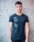 A short haired male model standing in front of wall wearing Viva La Vegan&