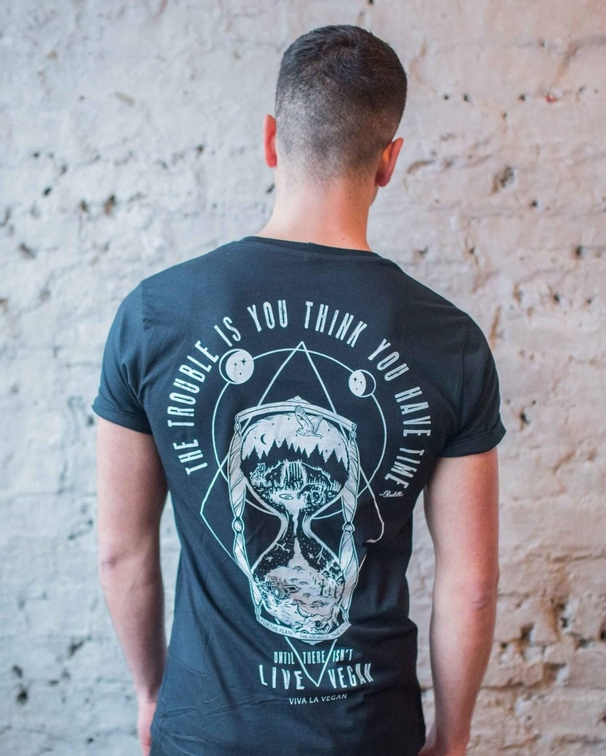 A picture of a male model facing a wall wearing one of Eco-Ethical brand Viva La Vegan&