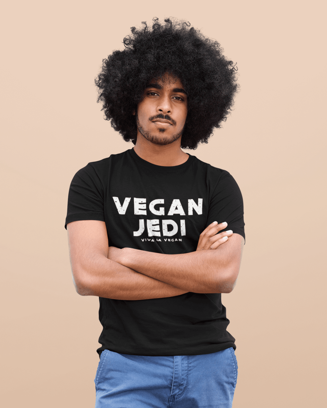 Unisex Vegan Jedi Tshirt in bMale Model with Afro-Hair wearing blue jeans and one of eco -ethical brand Viva La Vegans Vegan Jedi T-shirt in Black.