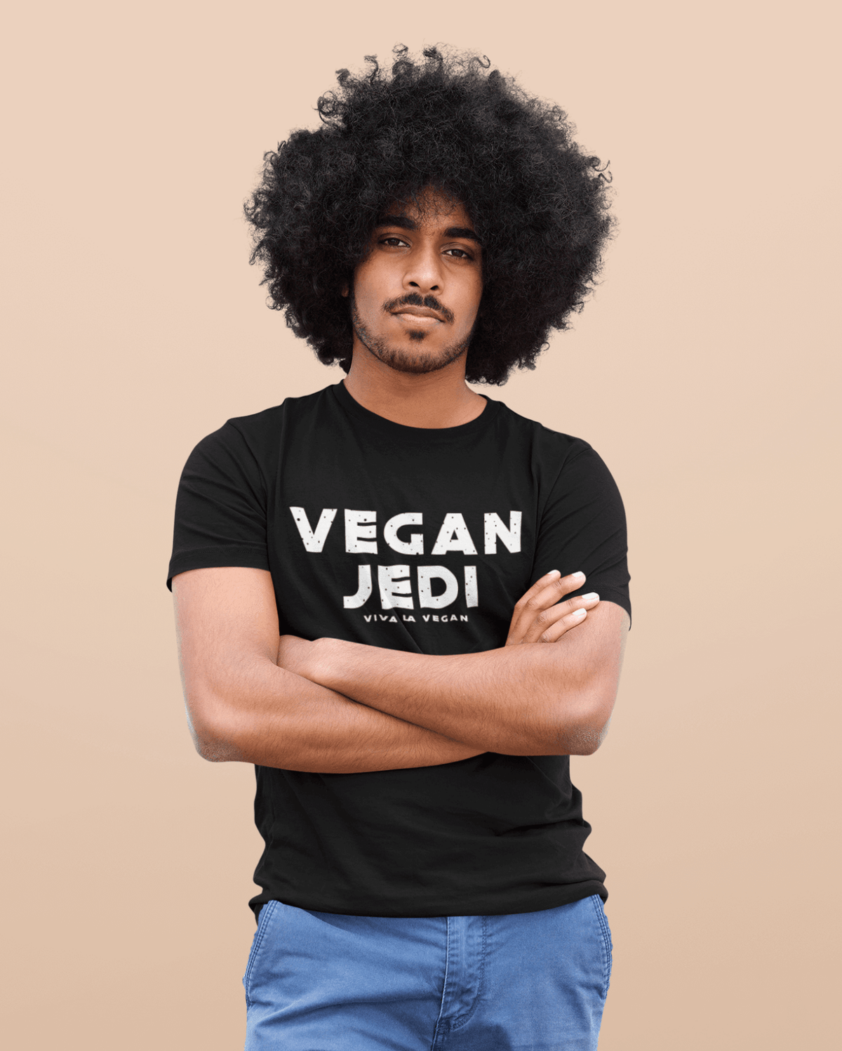 Unisex Vegan Jedi Tshirt in bMale Model with Afro-Hair wearing blue jeans and one of eco -ethical brand Viva La Vegans Vegan Jedi T-shirt in Black.