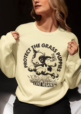 Cropped image of a woman wearing a unisex sweatshirt with crew neck, inset sleeves , torso print &