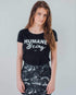 Female modelling the front of a black humane being vegan tshirt on a white background on behalf the Eco ethical vegan brand Viva La Vegan.